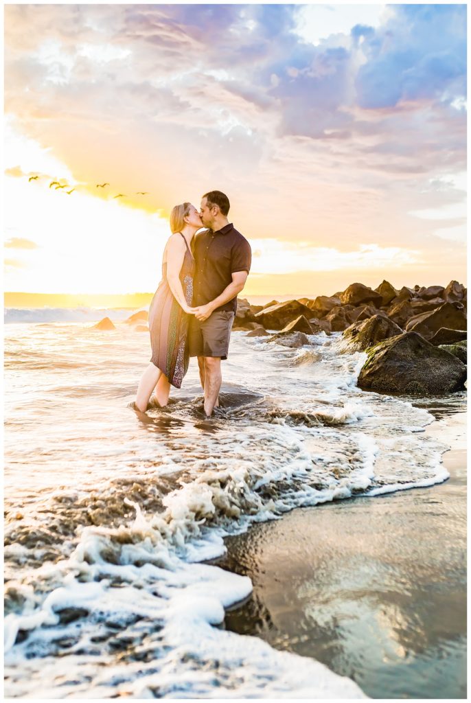 Couple kissing at Coronado Beach during their portrait session