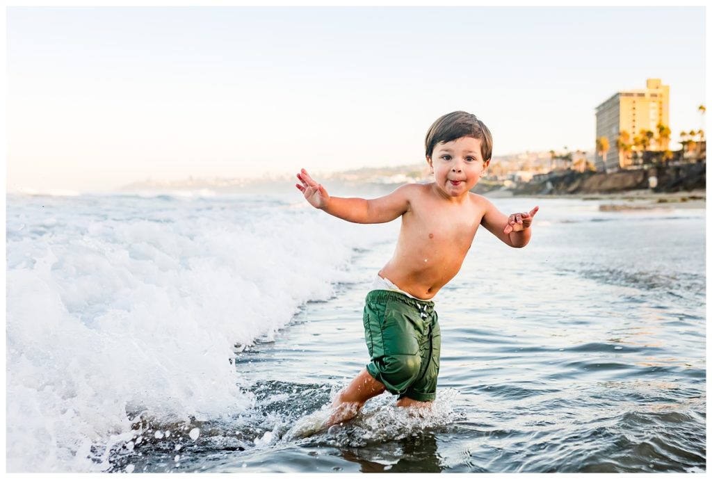 Boy playing in the ocean at Pacific Beach in San Diego
