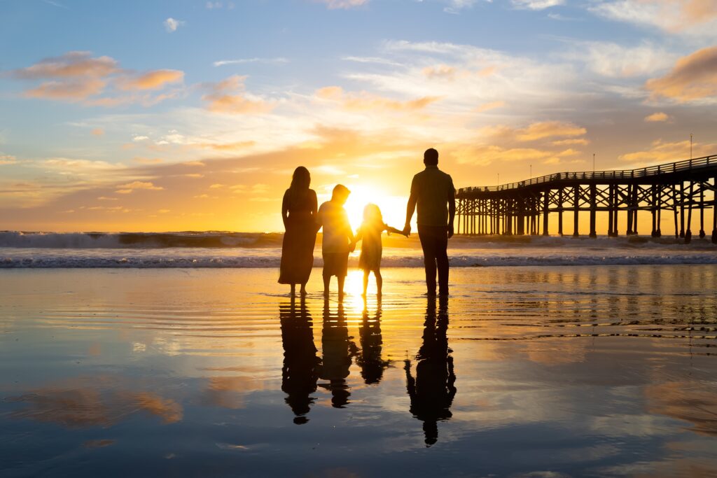 Silhouette photo of a family at the beach in San Diego