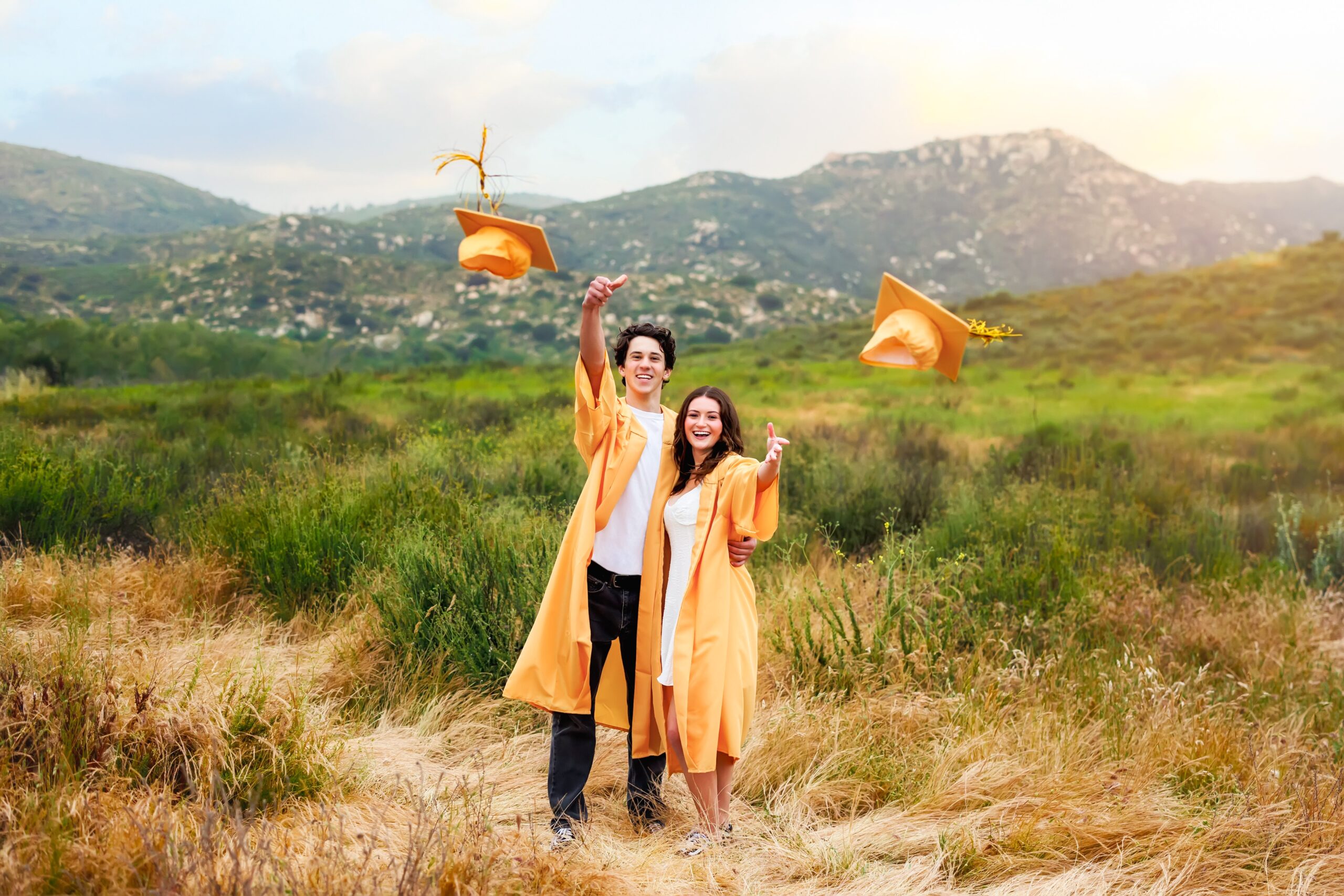 Two Temecula Valley High School seniors throwing their caps
