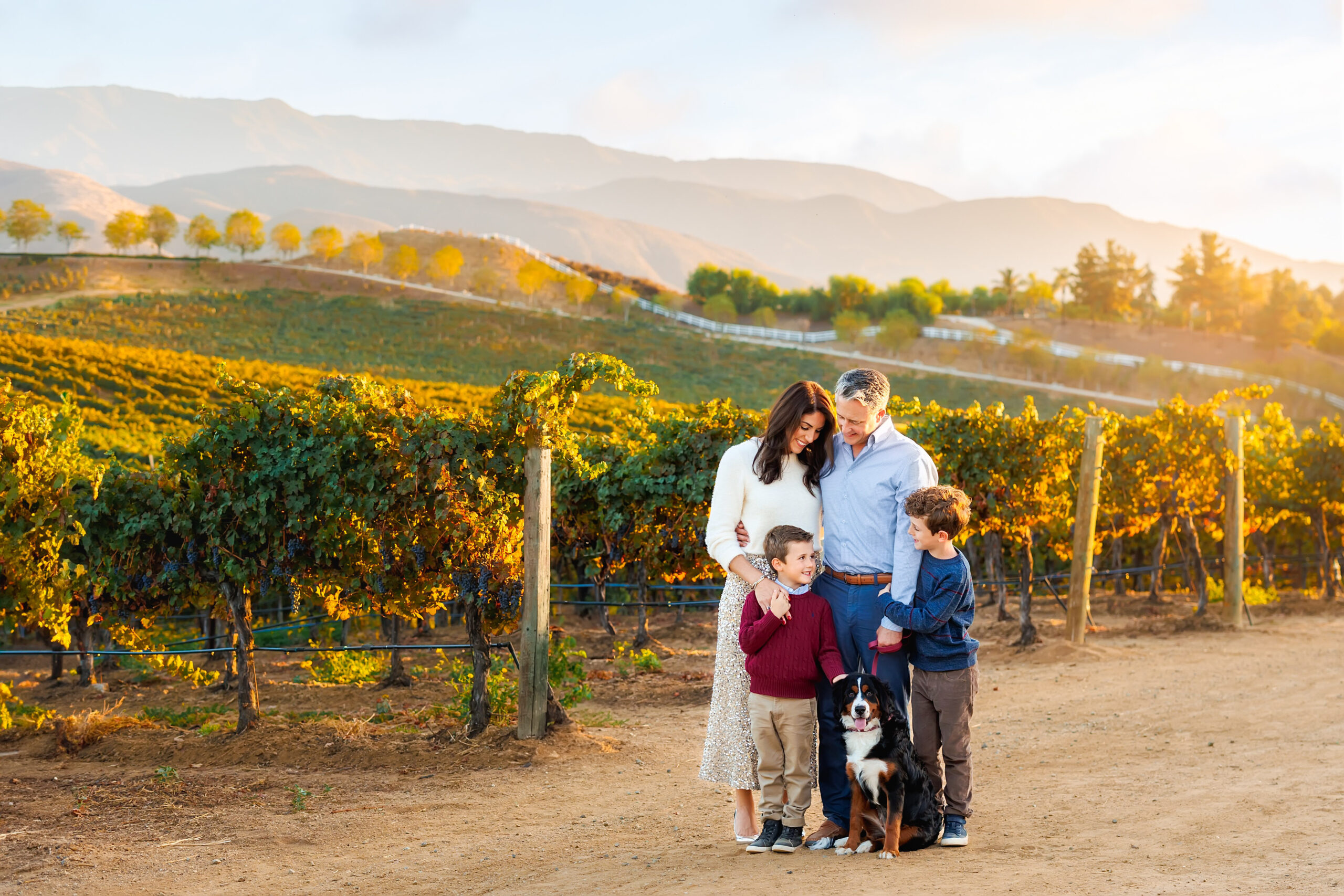 Family of 4 posing for portrait at Lorimar Winery in Temecula