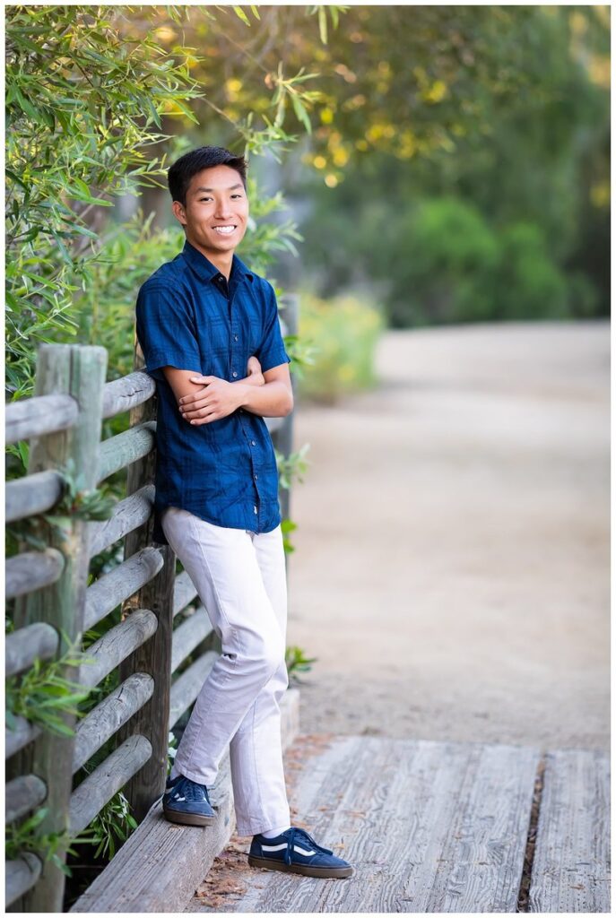 San Diego senior photograph of teen boy leaning on a fence