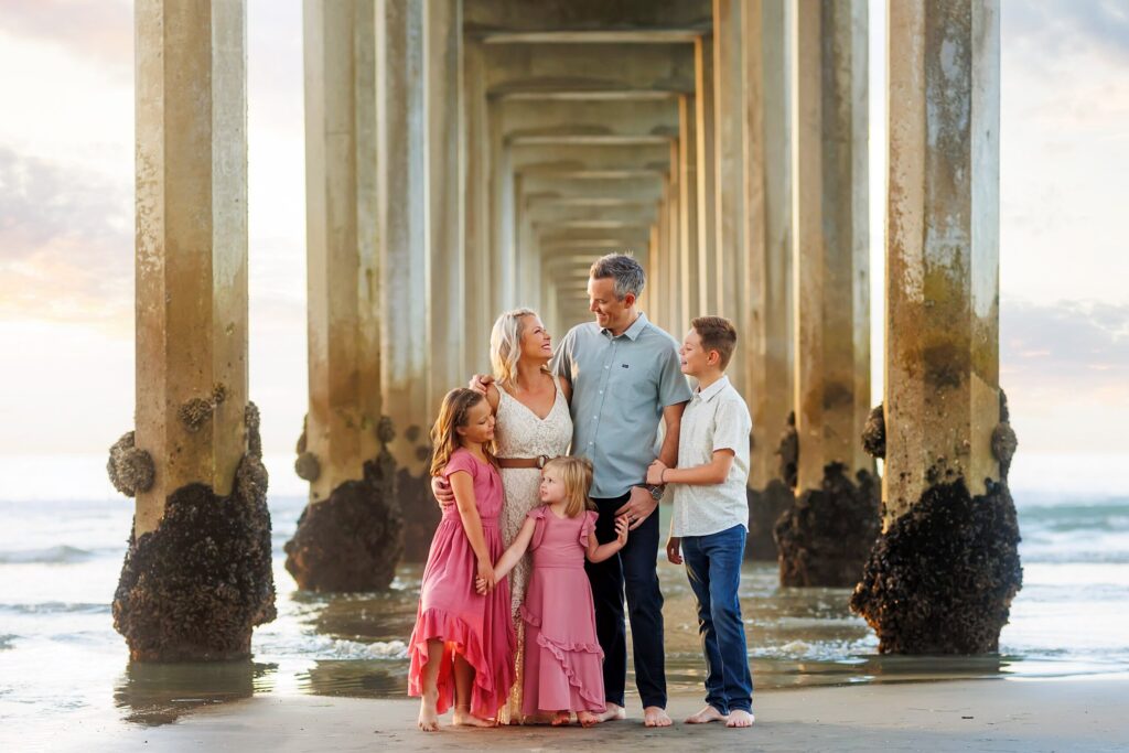Family posing under Scripps Pier in La Jolla